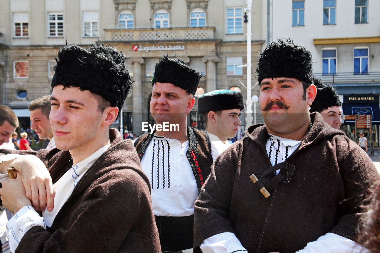 MEN IN TRADITIONAL CLOTHING OUTDOORS