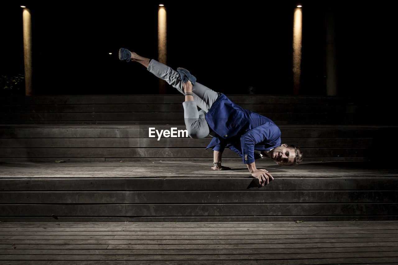 Man breakdancing on steps