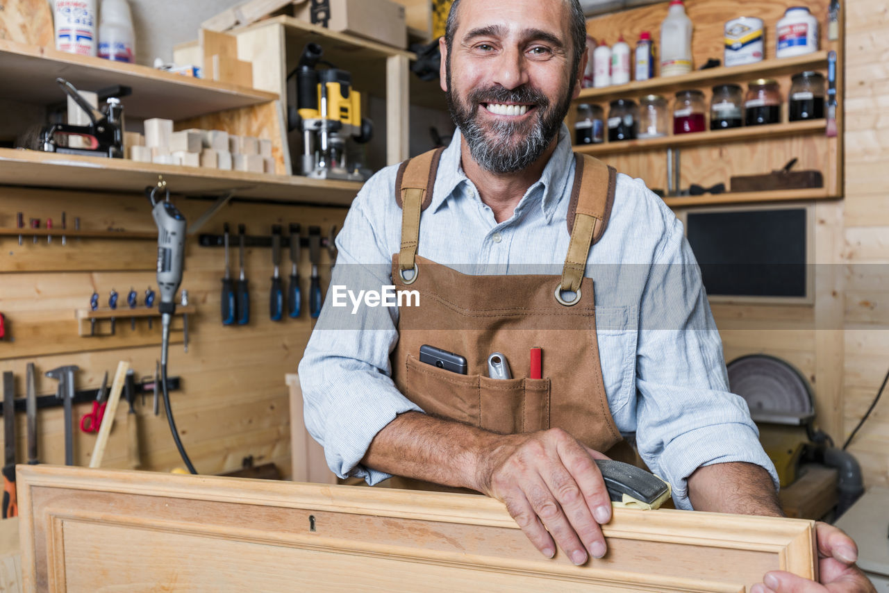 Portrait of smiling man working in workshop