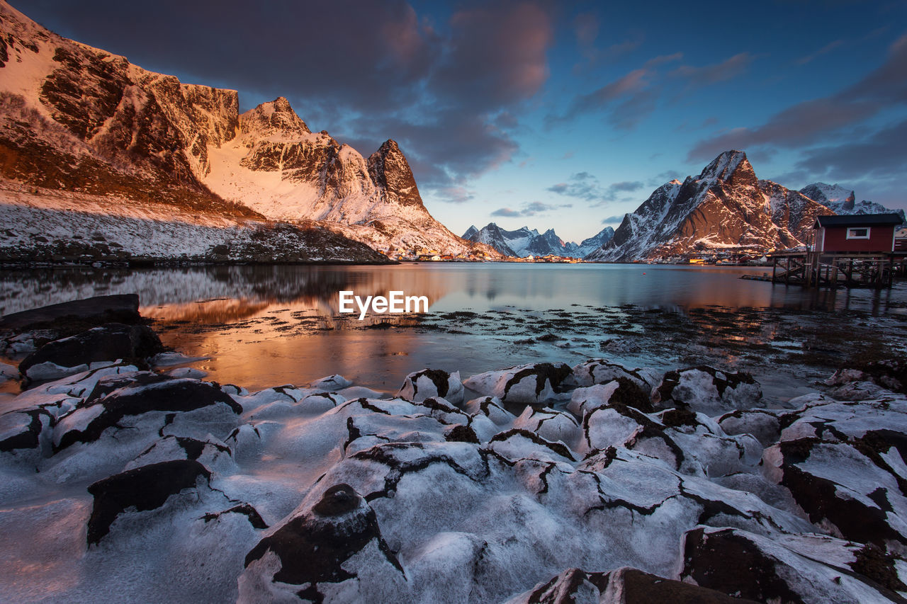 Scenic view of snowcapped mountains against sky during sunset