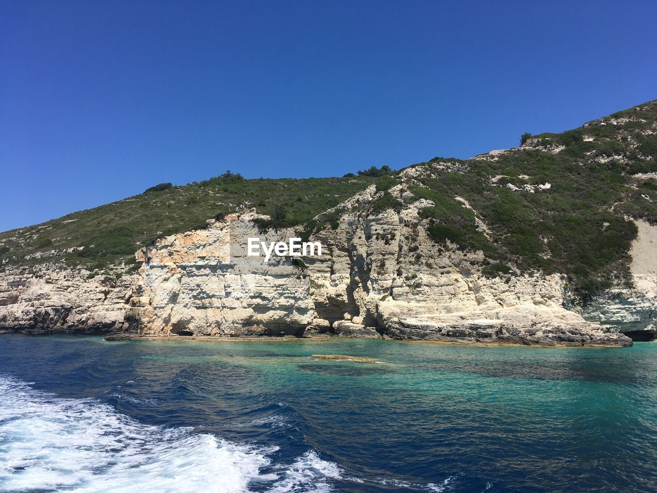 Scenic view of sea against clear blue sky