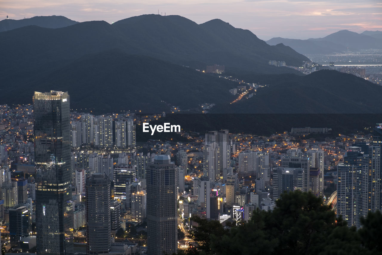 High angle view of illuminated buildings in city against sky