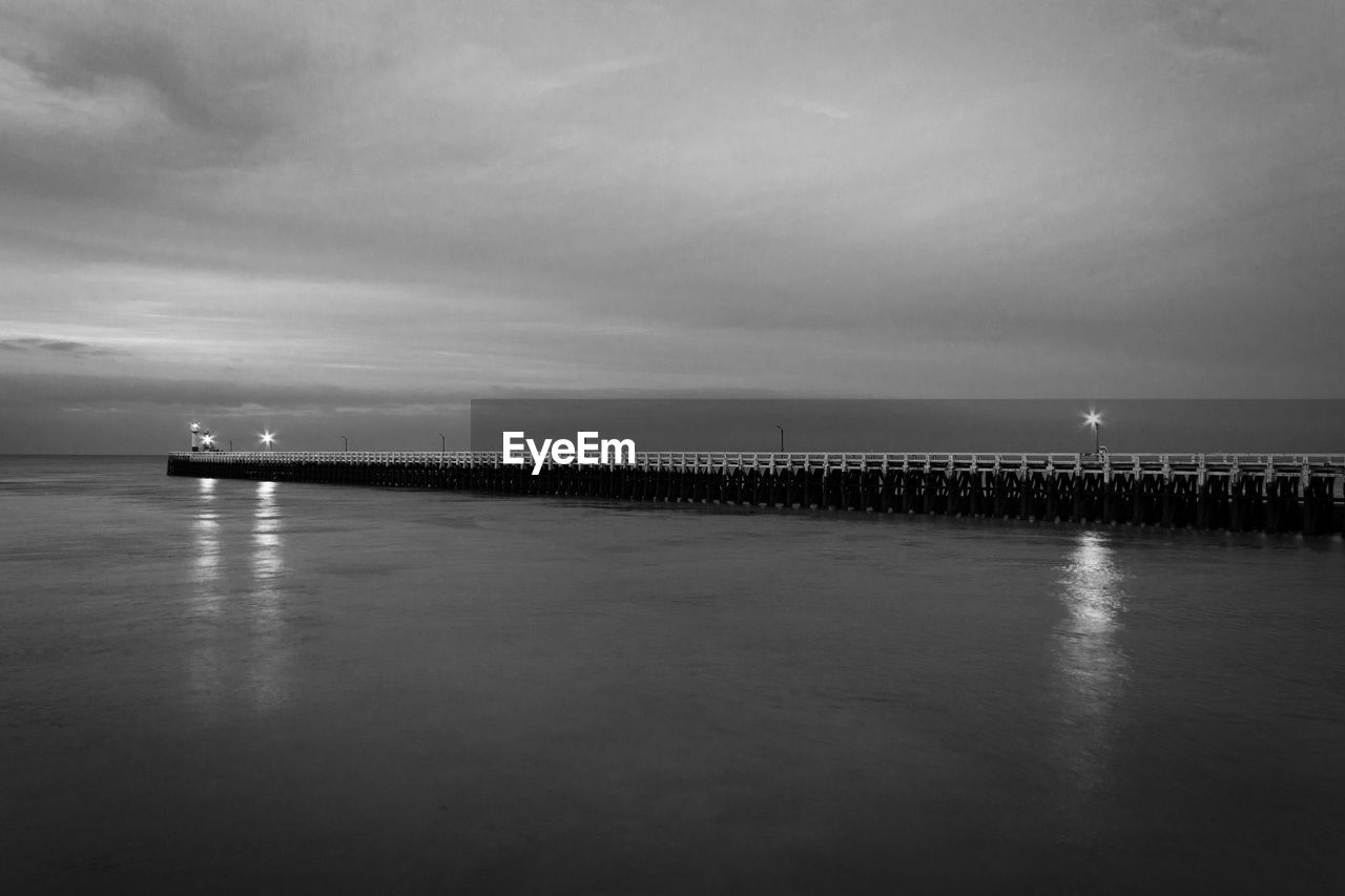 Pier over sea against sky