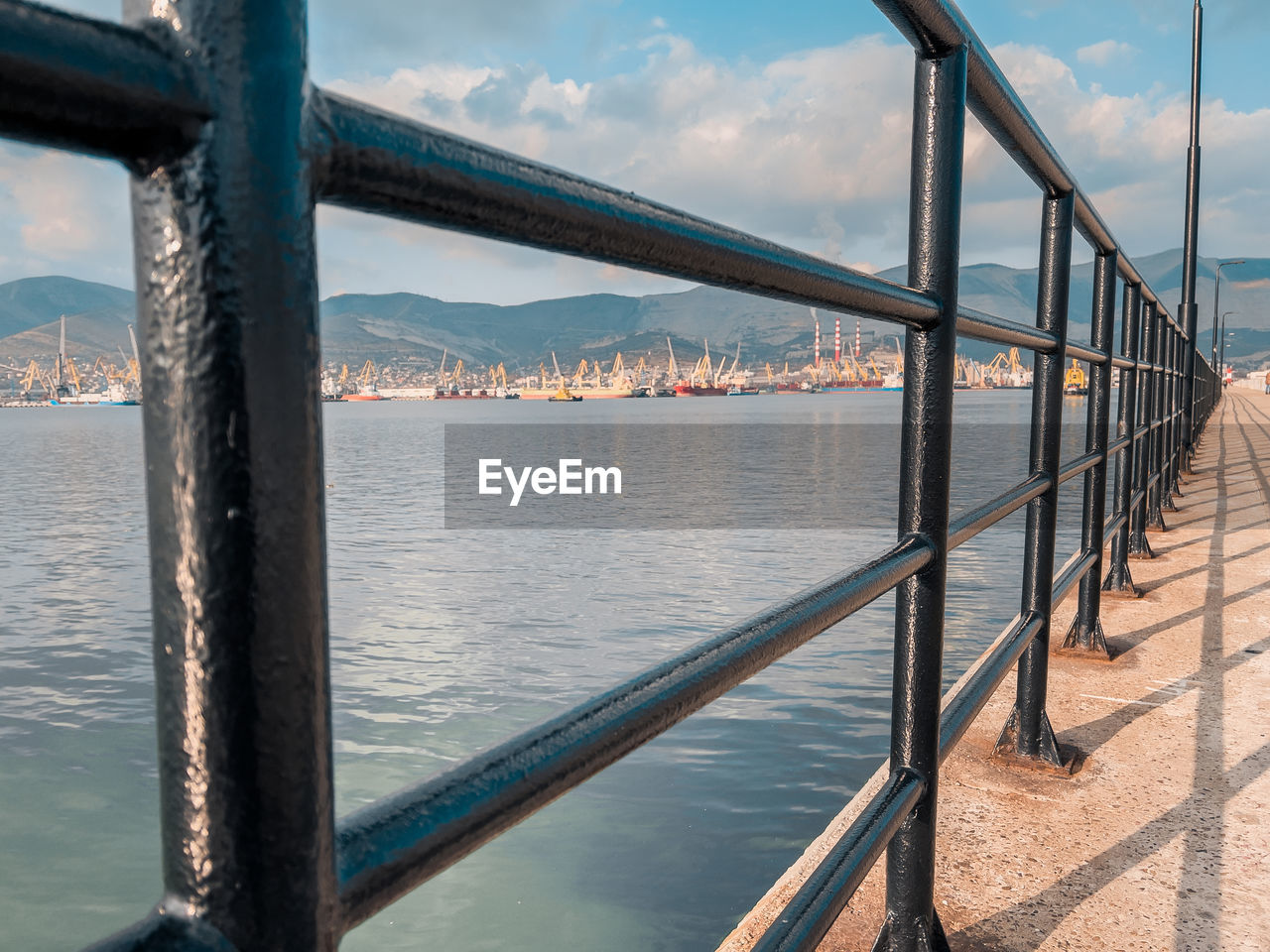 RAILING BY SEA AGAINST SKY