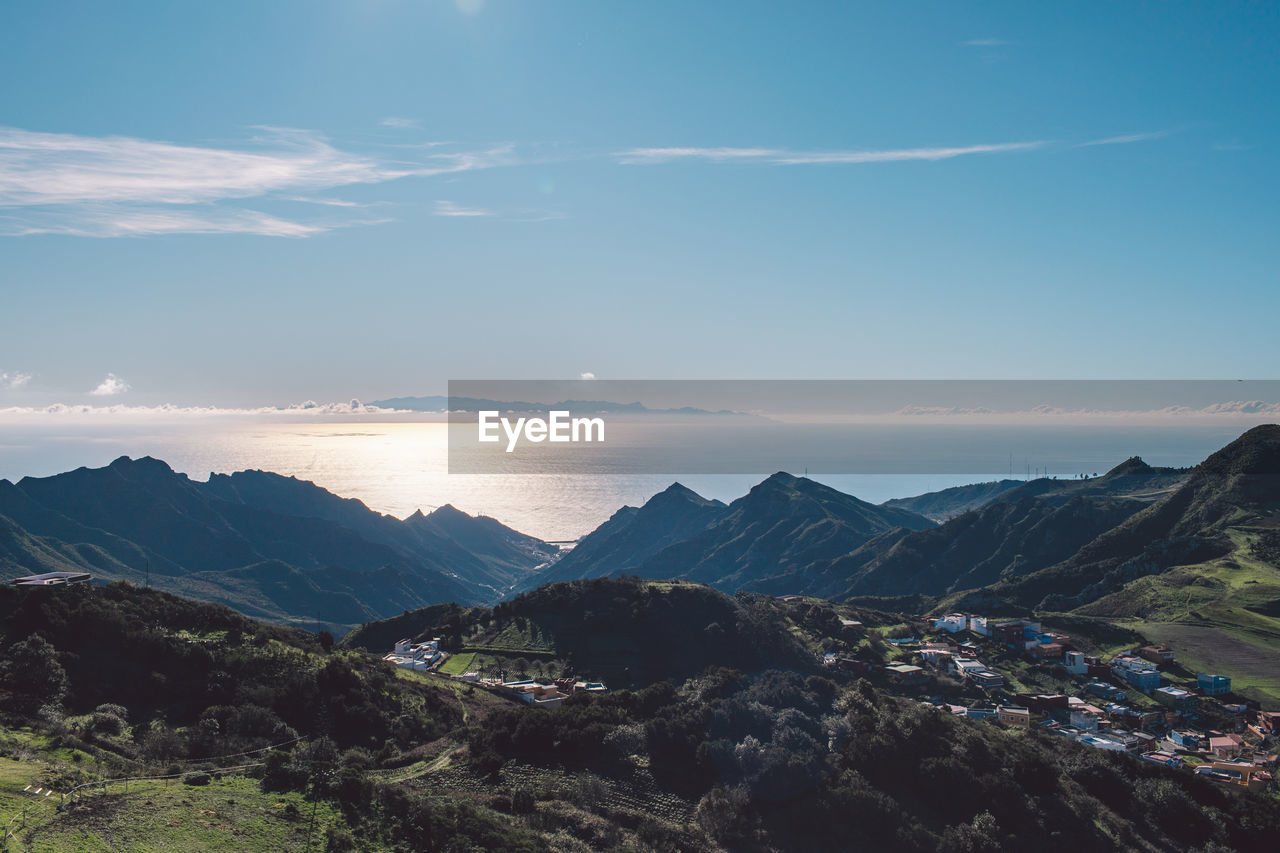 Scenic view of mountains against blue sky