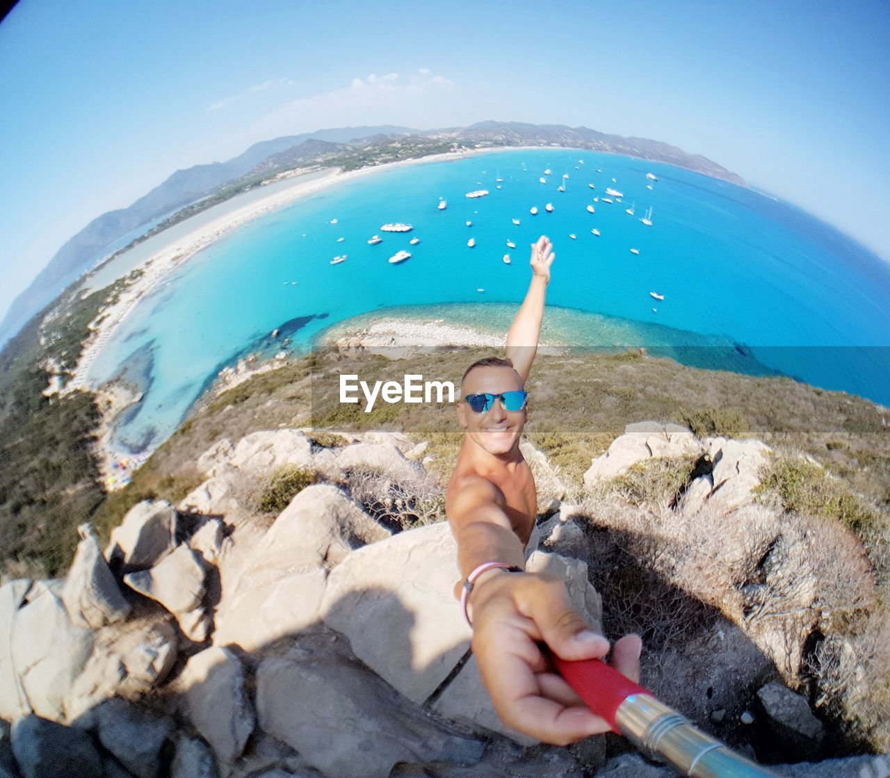 MIDSECTION OF SHIRTLESS MAN IN SEA AGAINST SKY