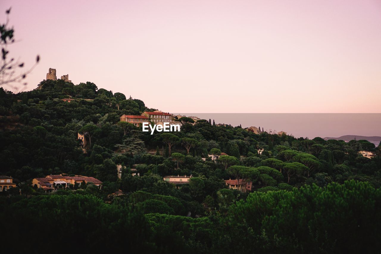 Buildings against clear sky during sunset