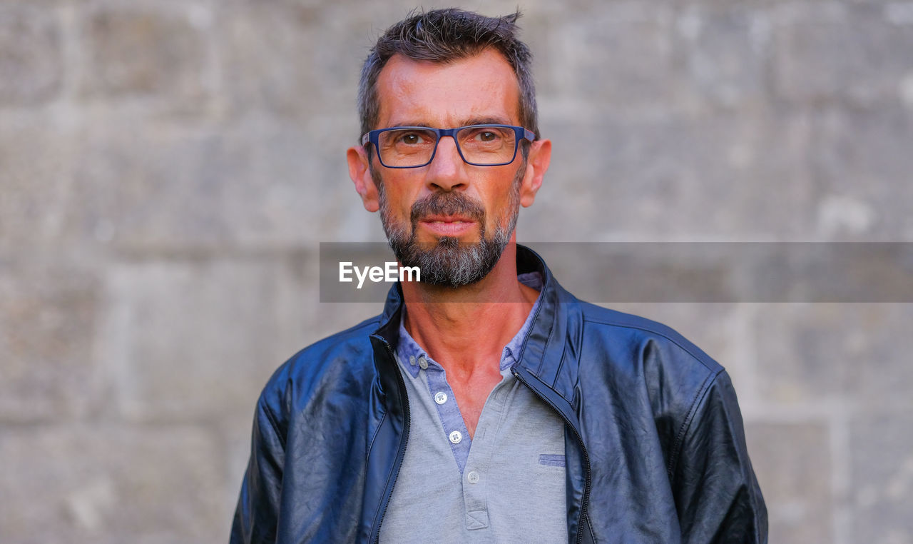 Portrait of man wearing eyeglasses standing outdoors