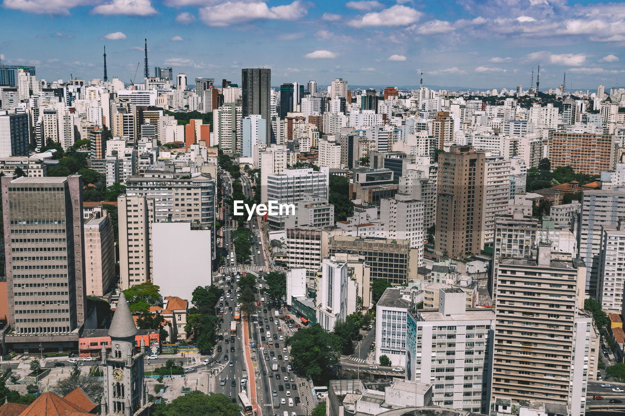 High angle view of cityscape against cloudy sky