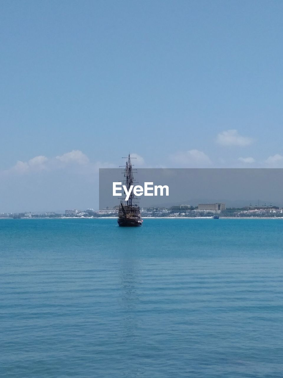 Sailboat in sea against sky