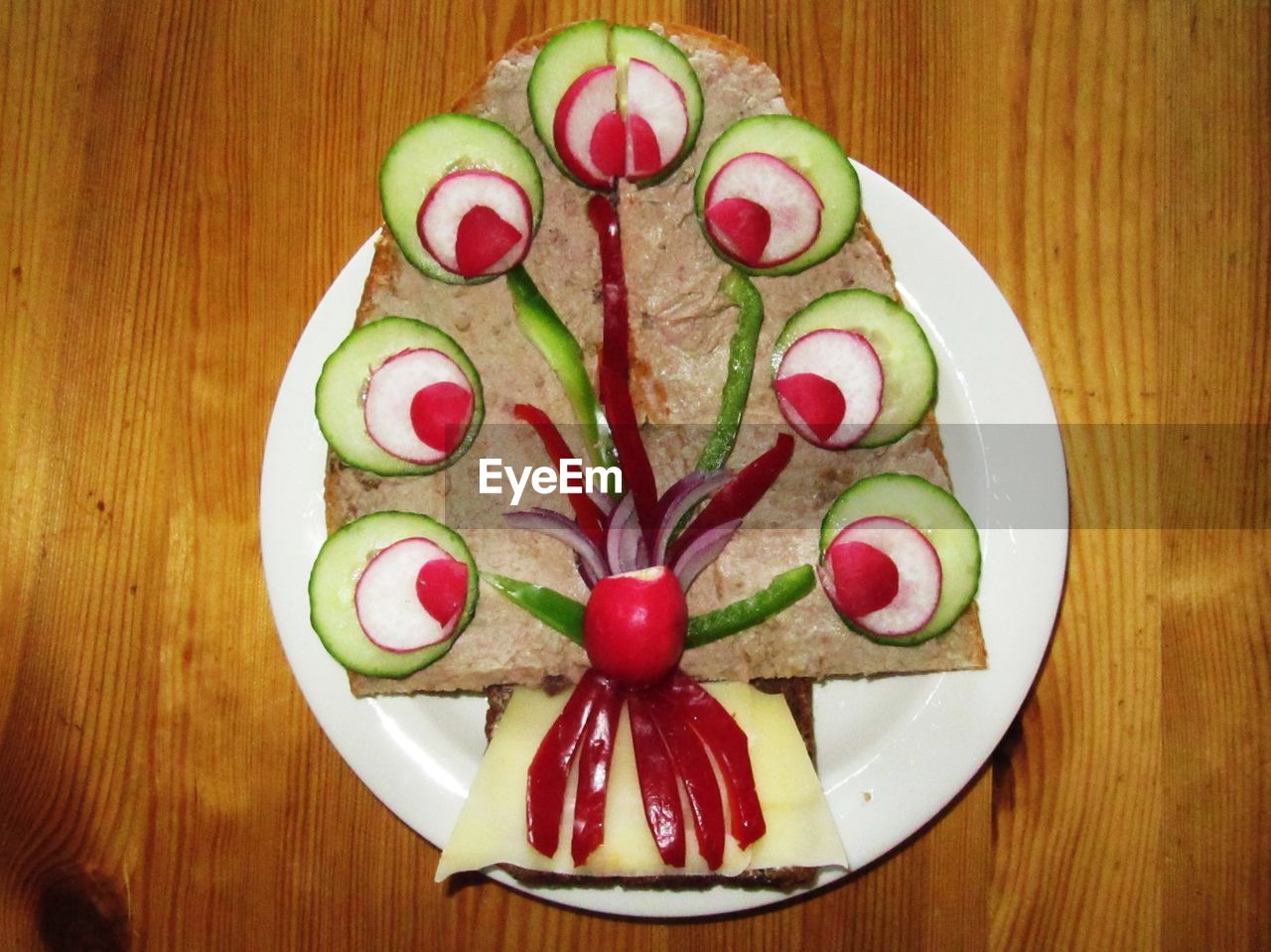 Symmetrical view of decorated sandwich on wooden table