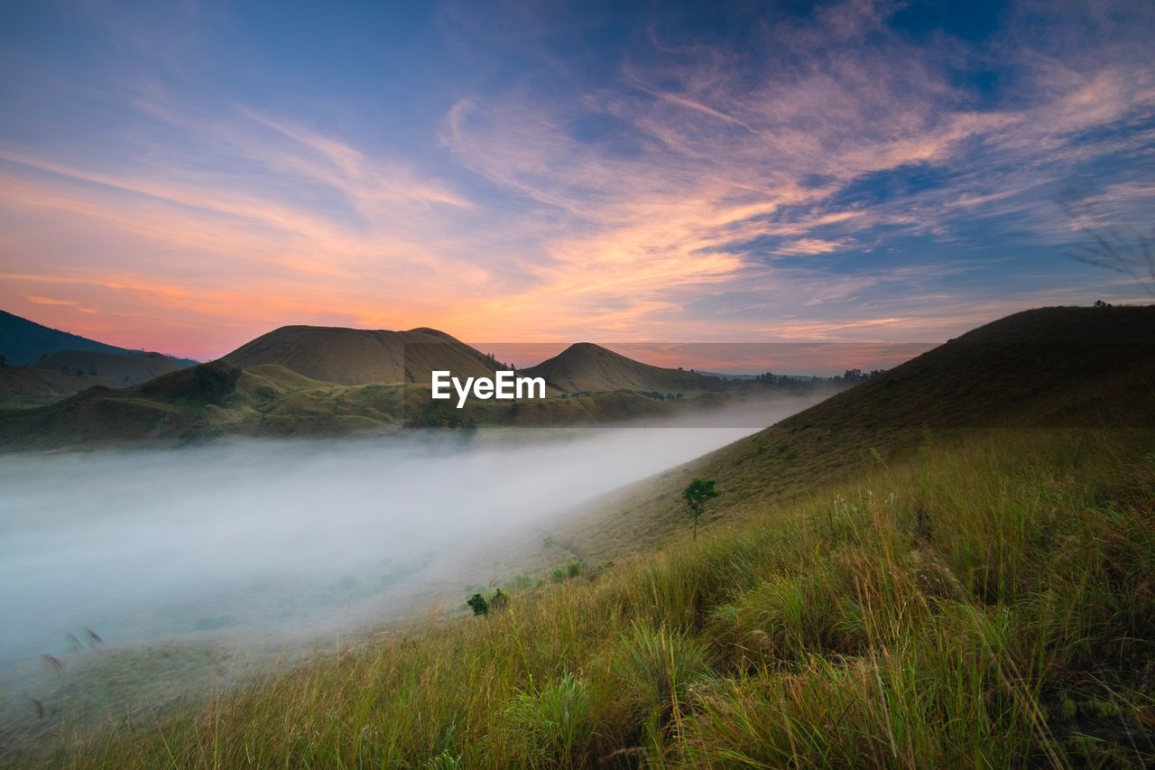 Scenic view of mountain against sky during sunset