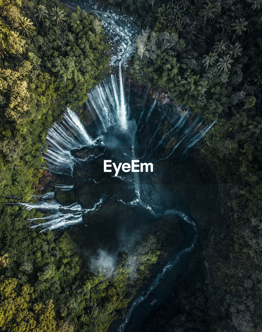 Drone view of water flowing through mountains