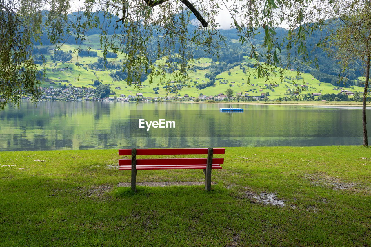 A calm place to rest and relax. an empty wooden bench. switzerland