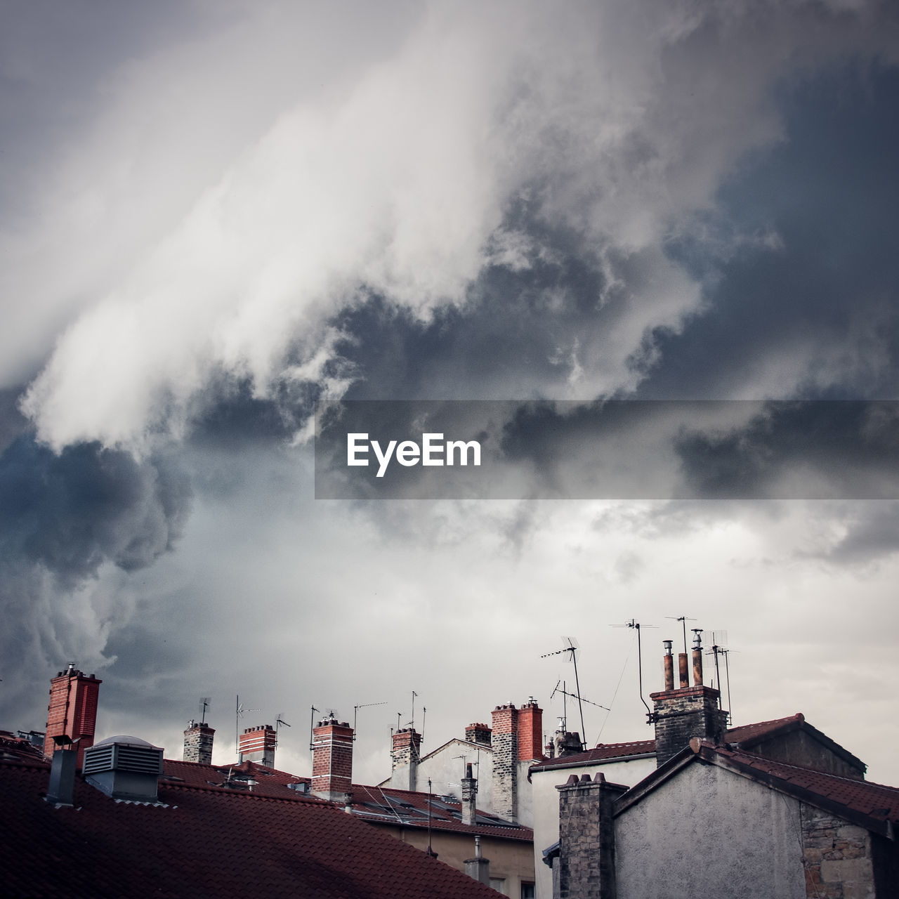 Buildings against cloudy sky