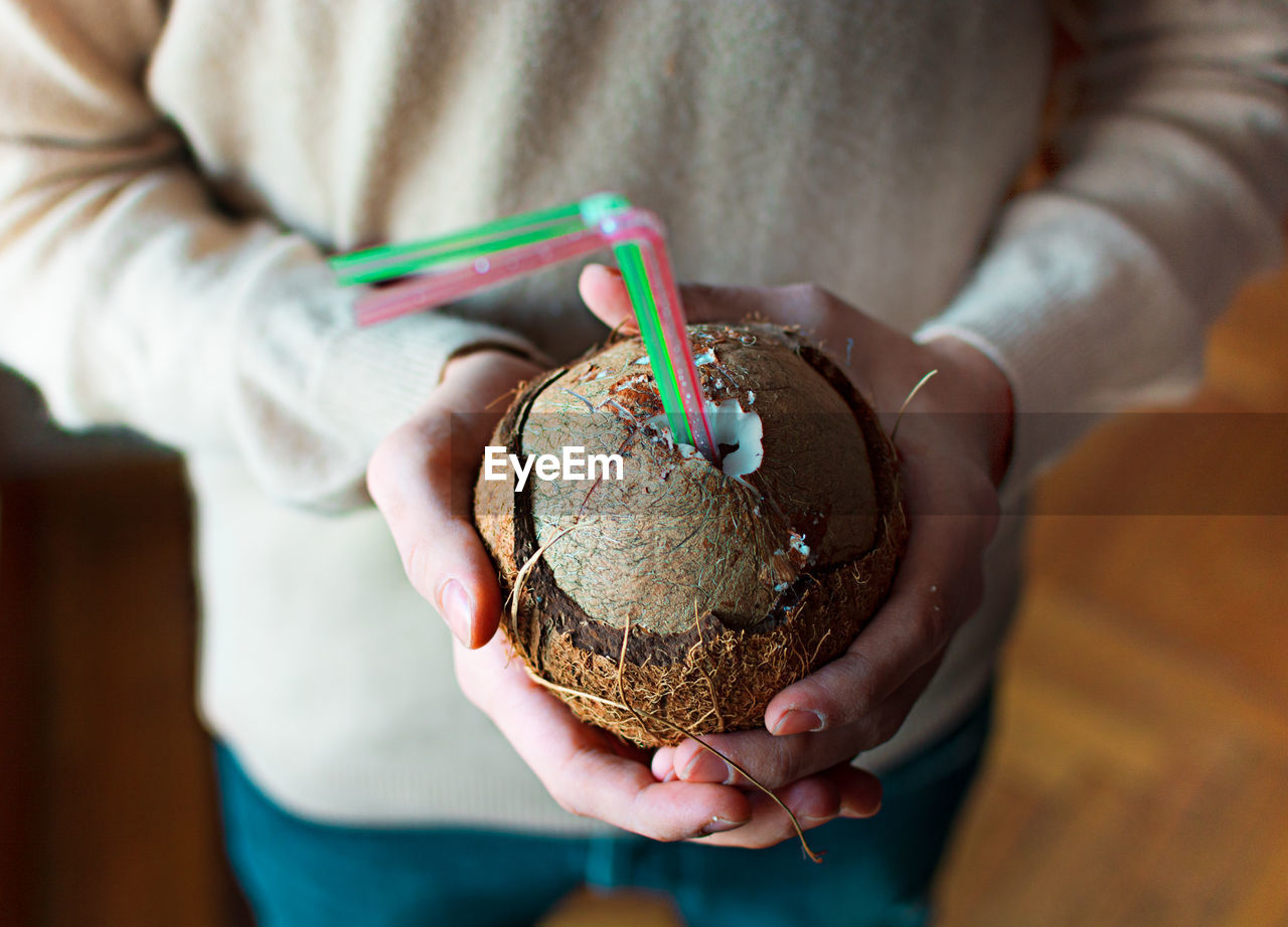 CLOSE-UP OF WOMAN HAND HOLDING ICE CREAM