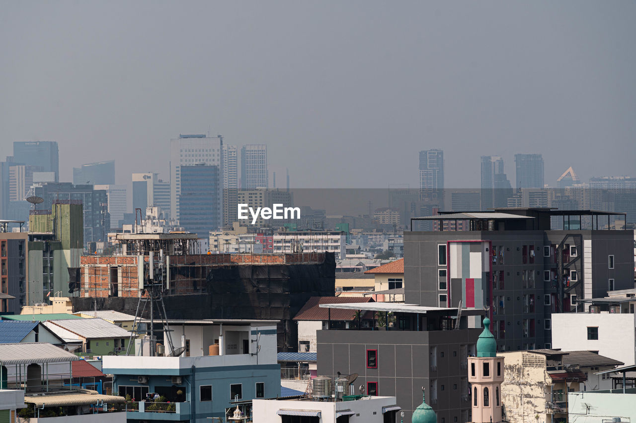 High angle view of buildings in city against sky