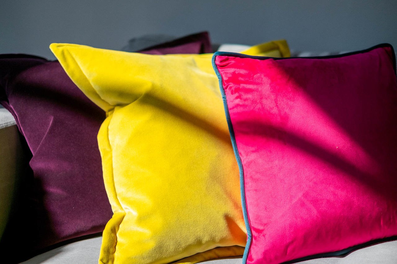 Close-up of multi colored cushions on bed