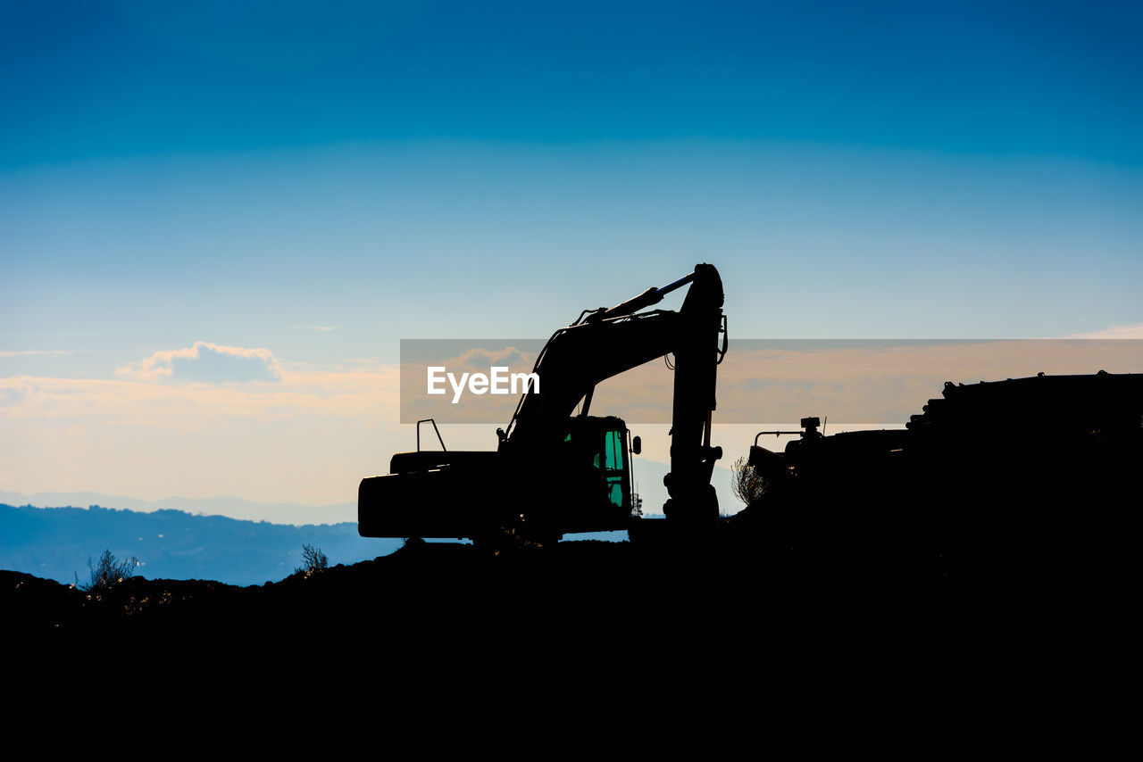 SILHOUETTE PEOPLE AT CONSTRUCTION SITE