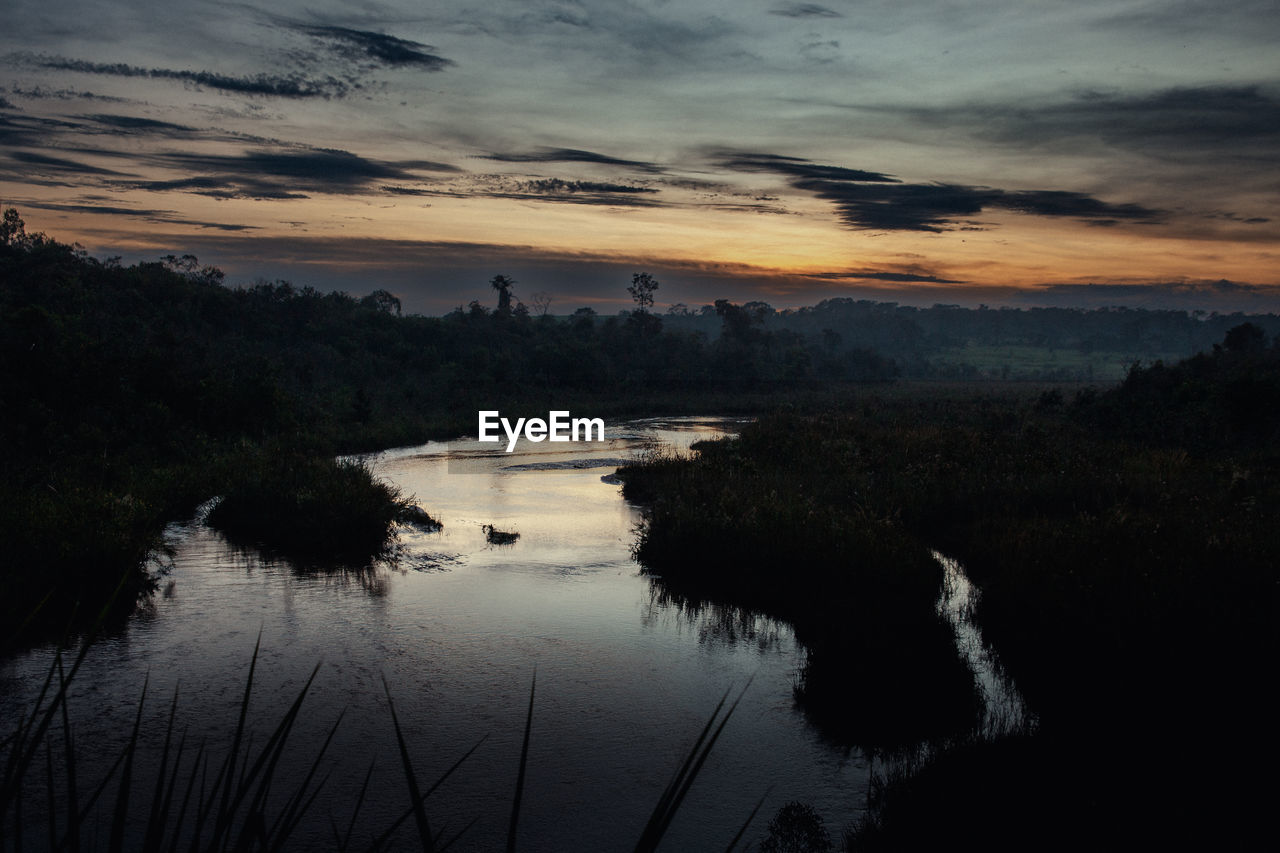 water, reflection, sky, nature, scenics - nature, dawn, environment, morning, cloud, beauty in nature, landscape, tree, tranquility, plant, sunrise, lake, no people, land, tranquil scene, forest, travel destinations, outdoors, travel, sun, non-urban scene, silhouette, tourism, twilight