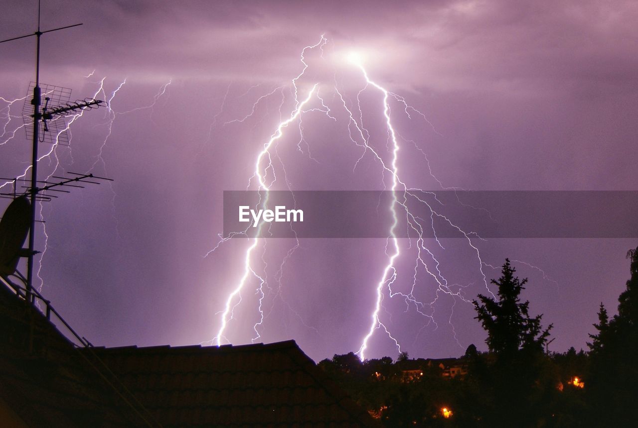 Low angle view of lightning against sky at night