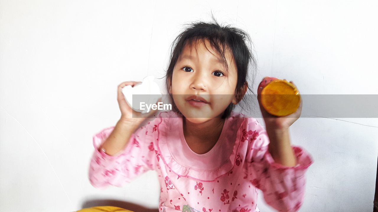 PORTRAIT OF CUTE GIRL HOLDING ICE CREAM IN PLATE