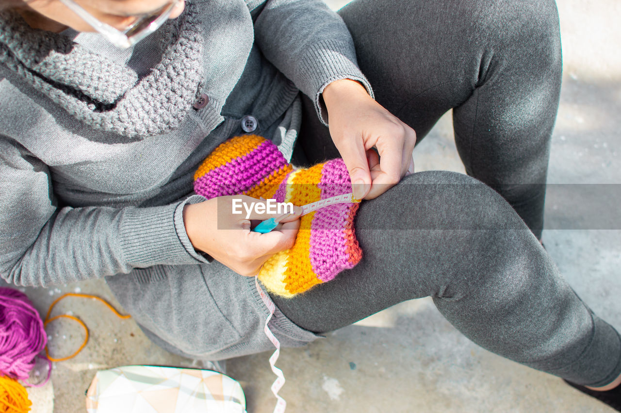 CLOSE-UP OF HANDS HOLDING MULTI COLORED