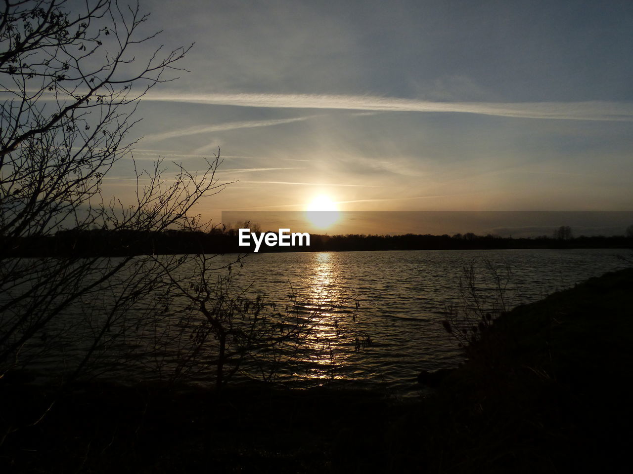 SCENIC VIEW OF SUNSET OVER LAKE