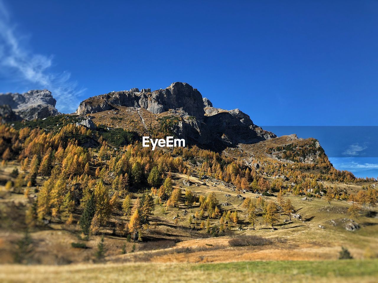 Scenic view of rocky mountains against blue sky