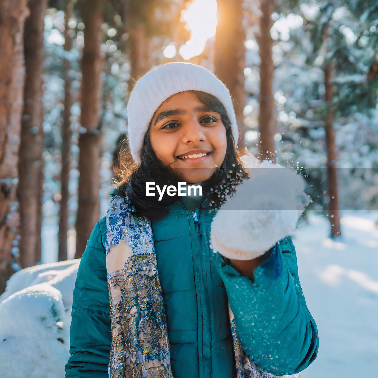 Portrait of young woman standing in forest. the joy of the winter.