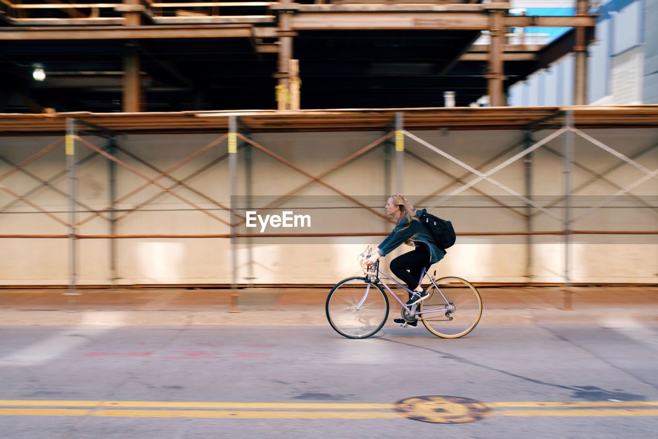 MAN RIDING BICYCLE ON BICYCLE