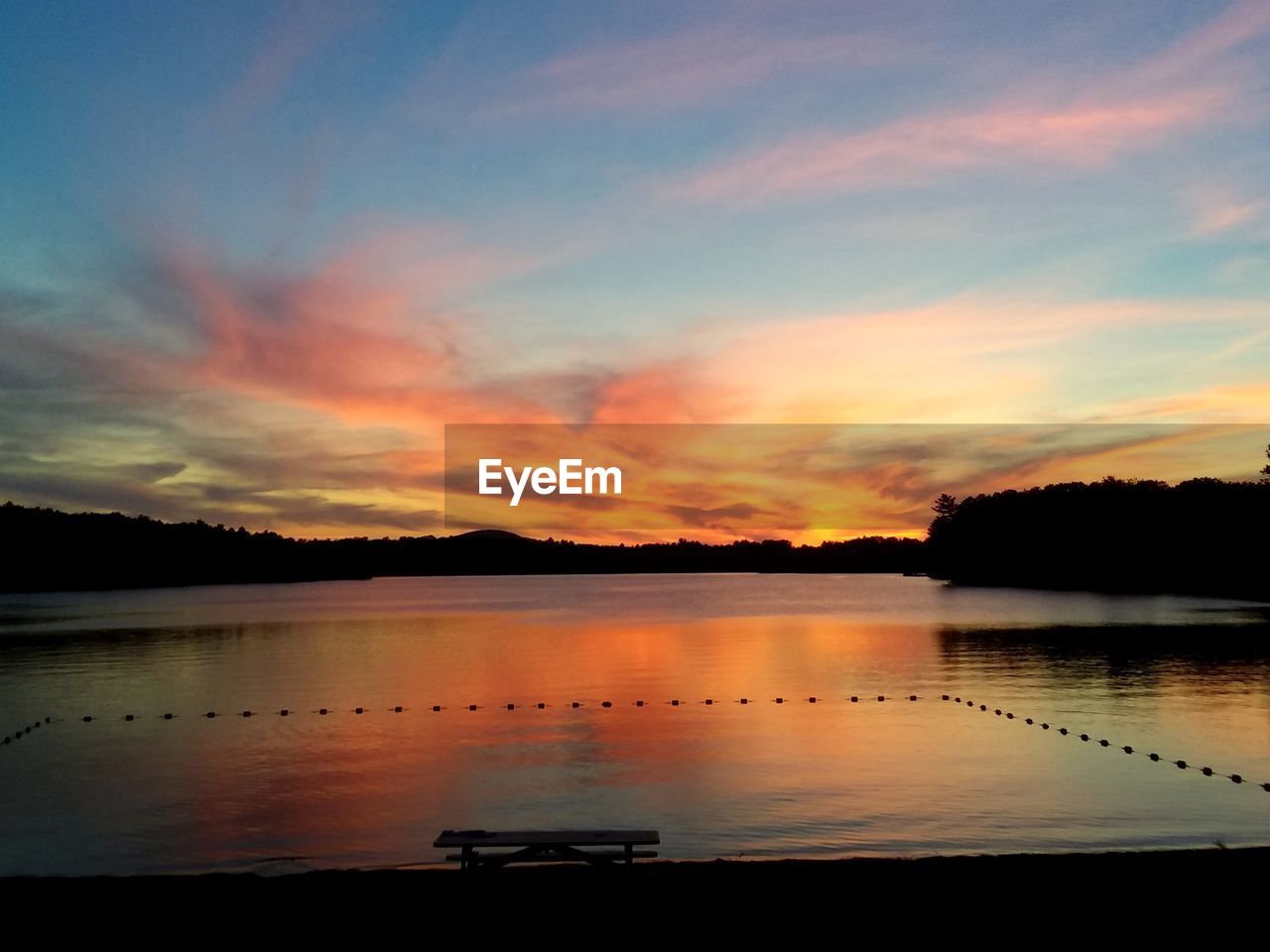 SCENIC VIEW OF LAKE AGAINST ORANGE SKY DURING SUNSET