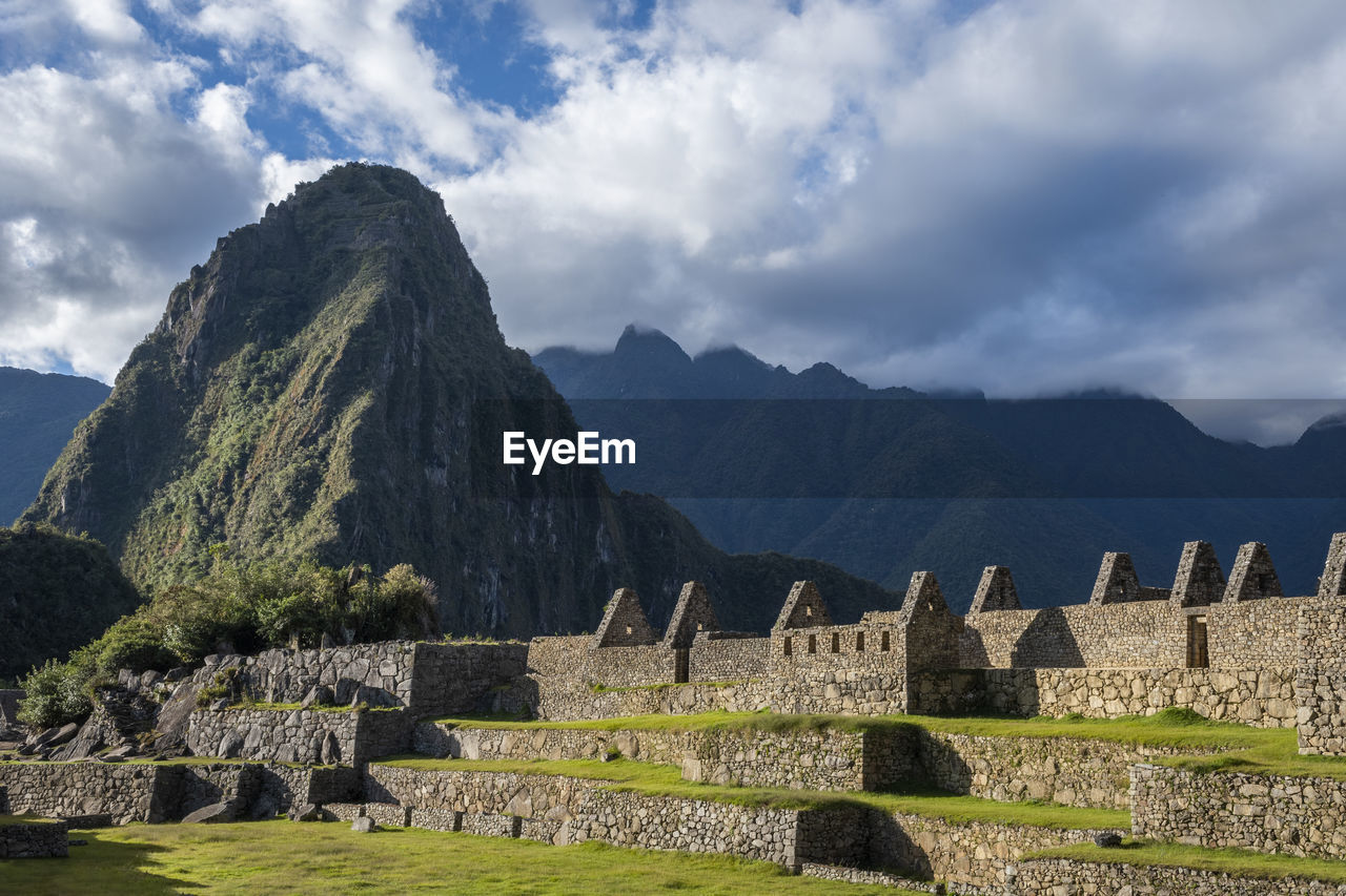 VIEW OF RUINS OF MOUNTAINS AGAINST CLOUDY SKY