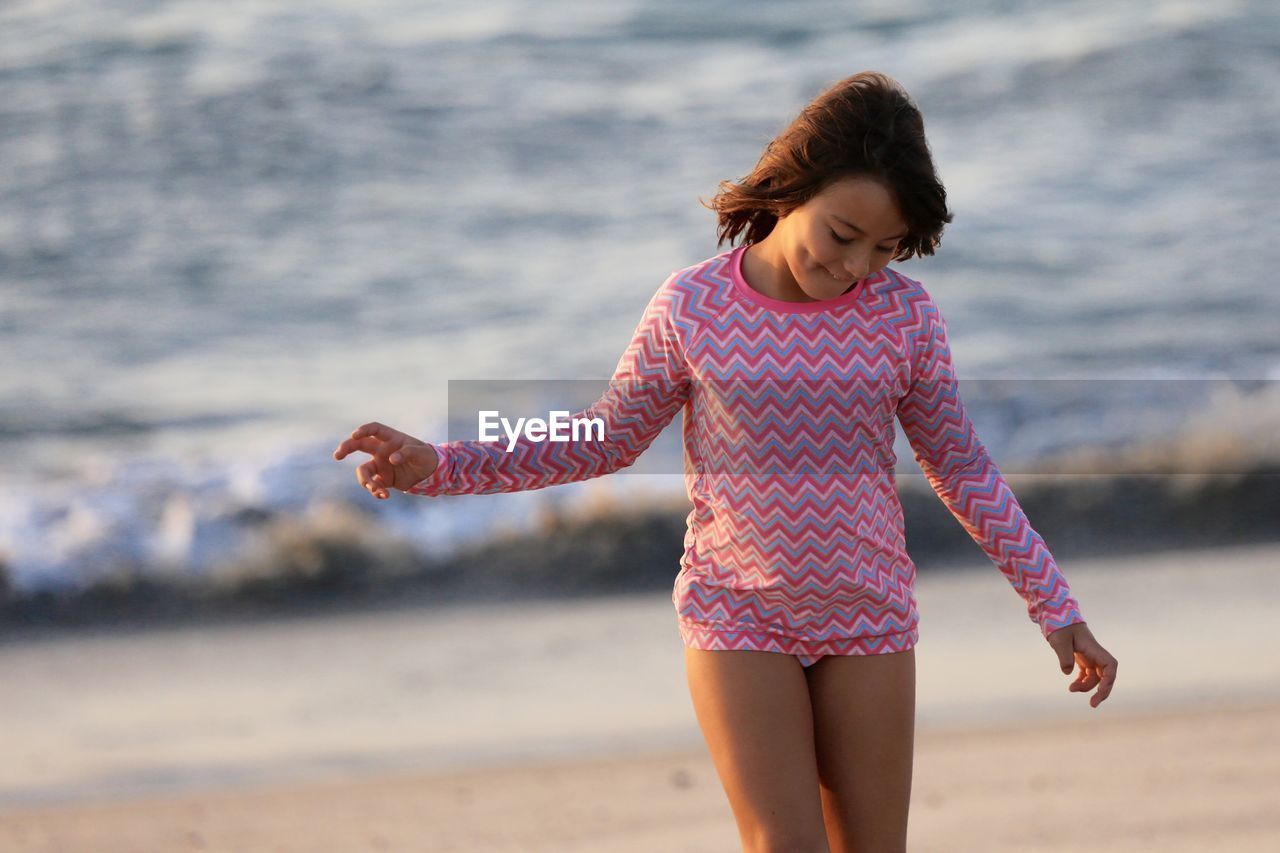 Front view of girl in pink at beach