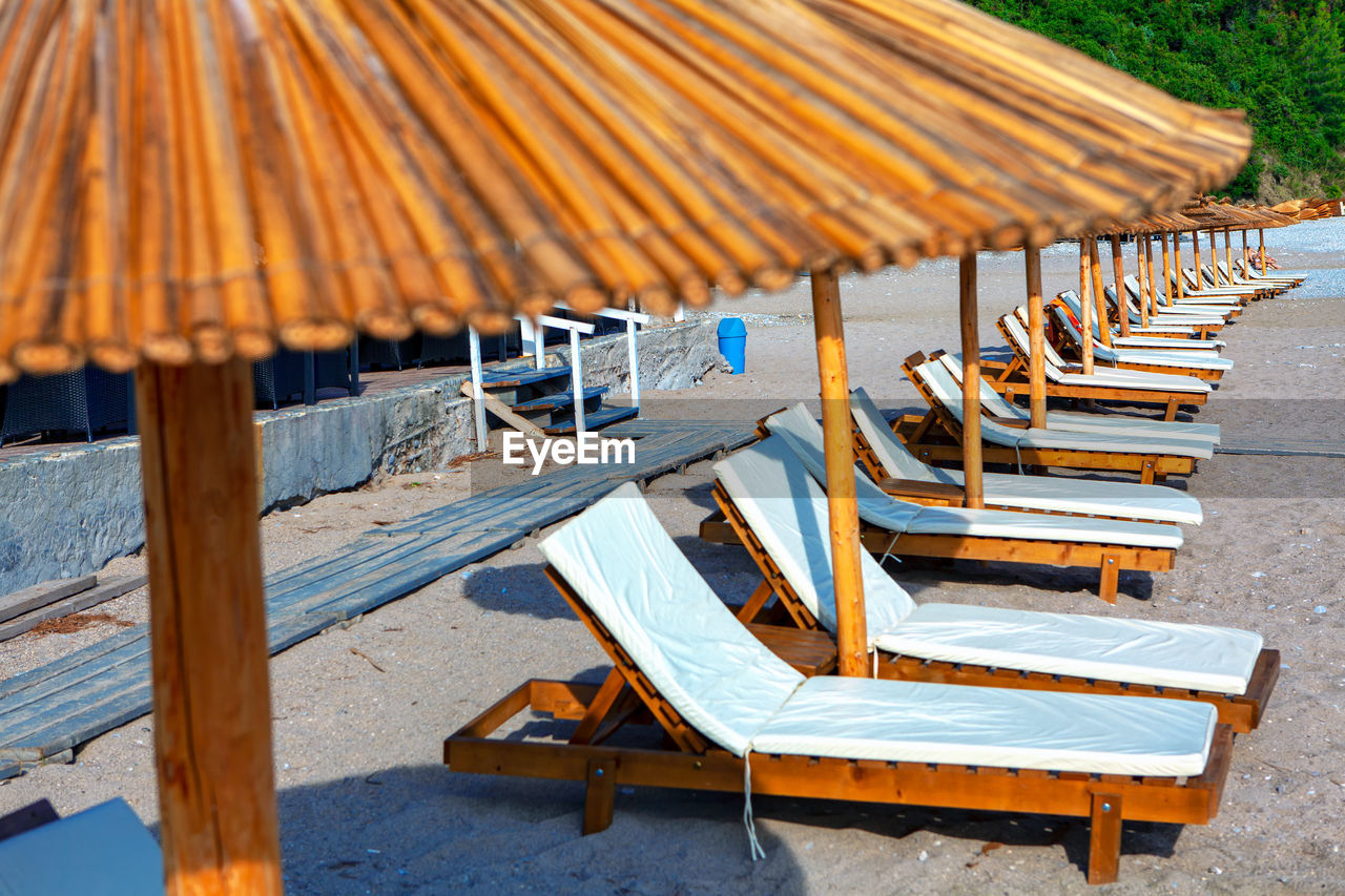Beautiful exotic beach with sun loungers . summer vacation . sun umbrellas at the sunny sandy beach