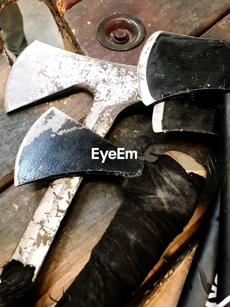 High angle view of axes on table at workshop