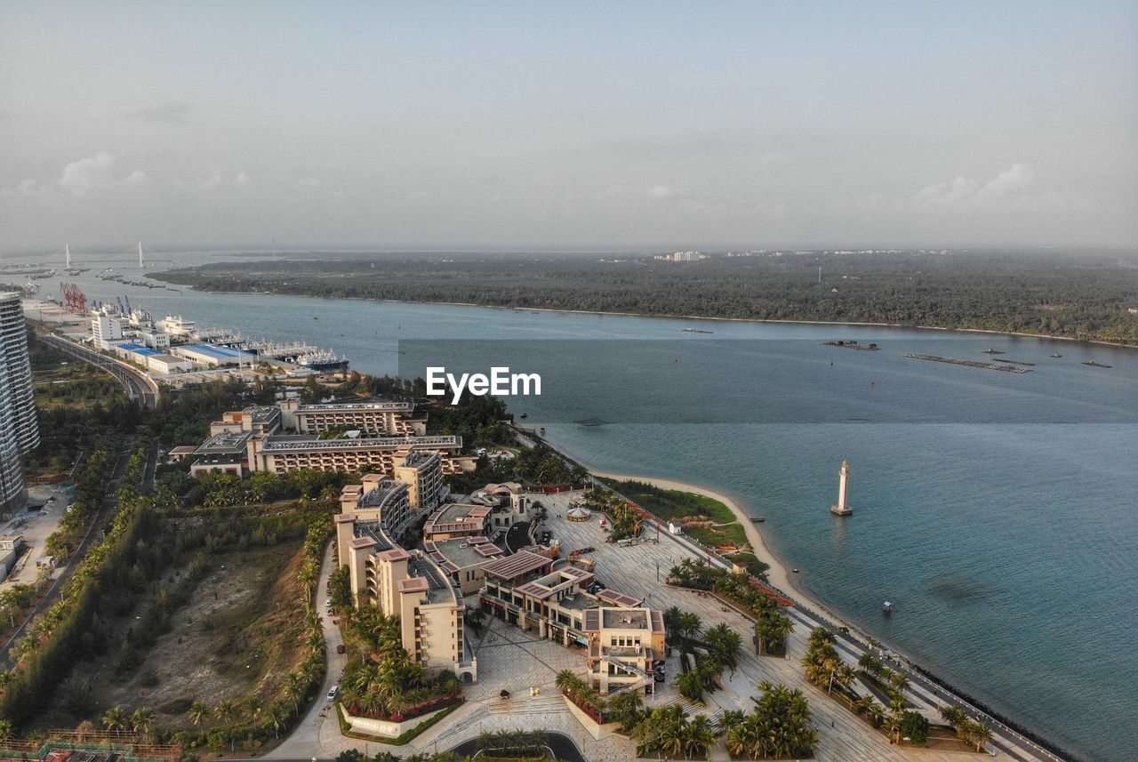 High angle view of sea and buildings against sky