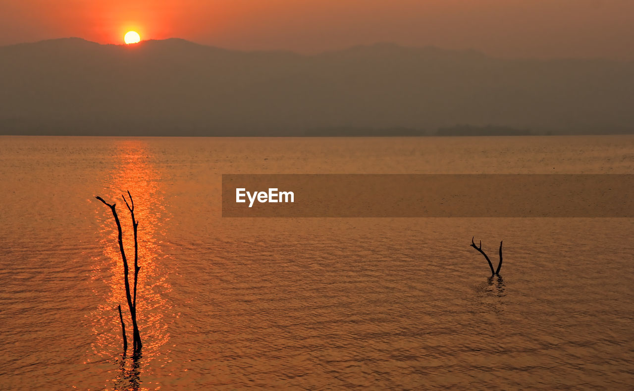 SCENIC VIEW OF SUNSET OVER SEA