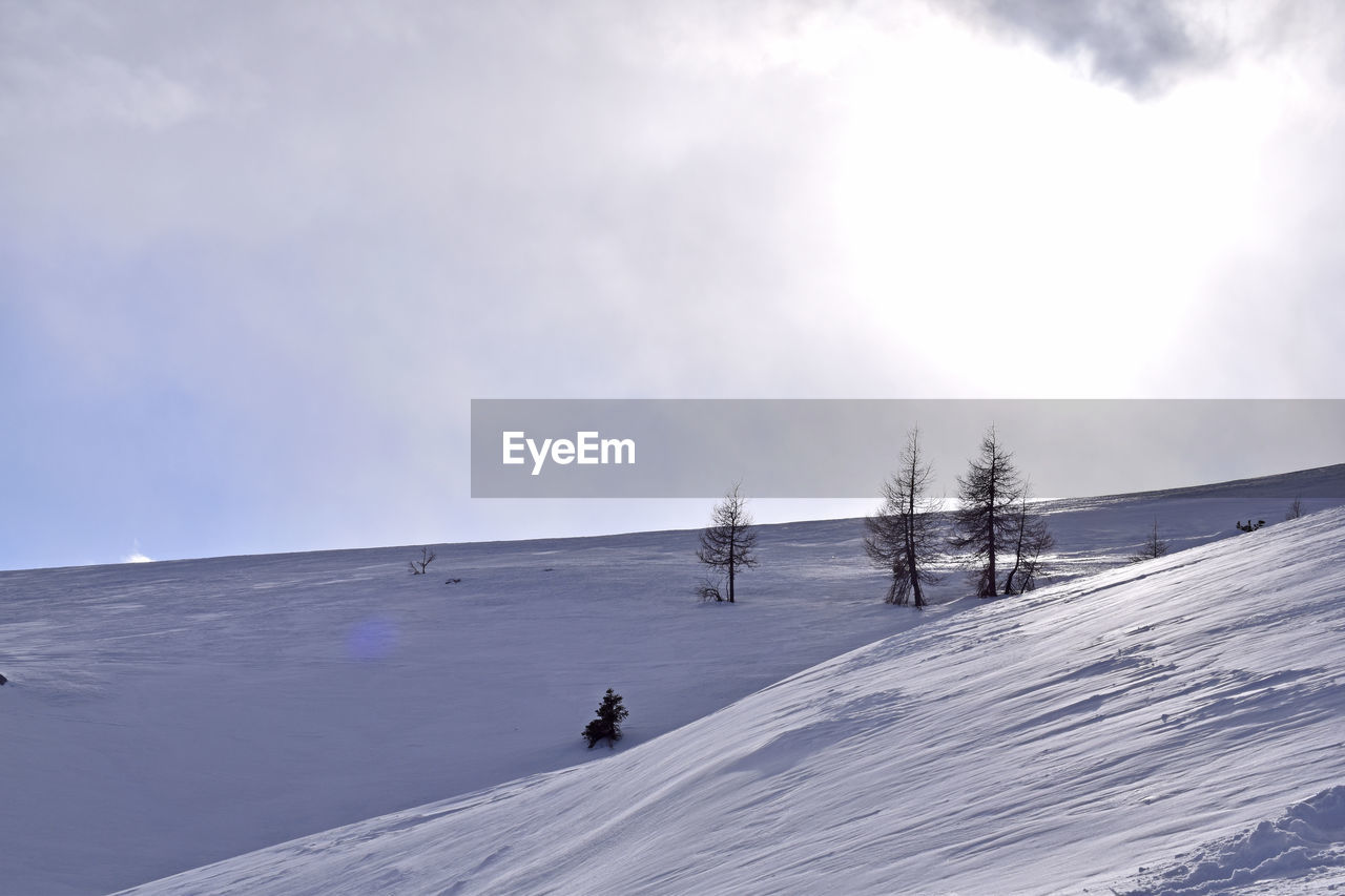 PEOPLE ON SNOW COVERED MOUNTAINS AGAINST SKY