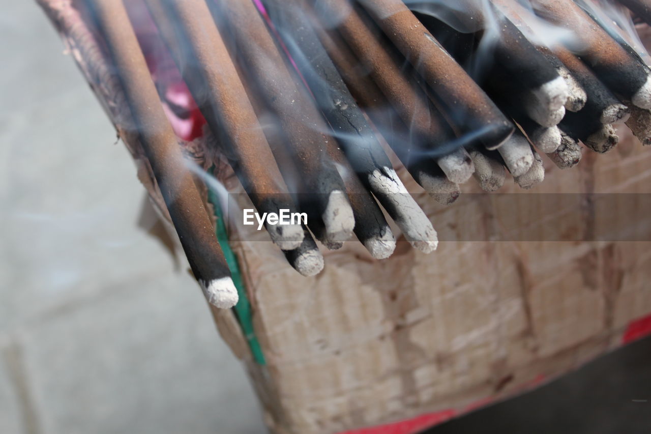 Close-up of lit incense sticks at temple