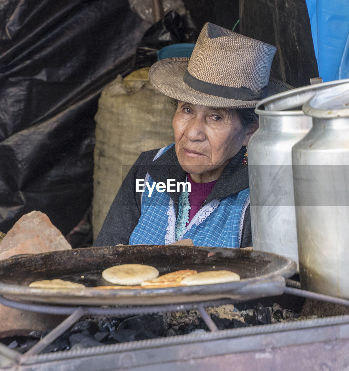 PORTRAIT OF MAN SITTING IN A MARKET