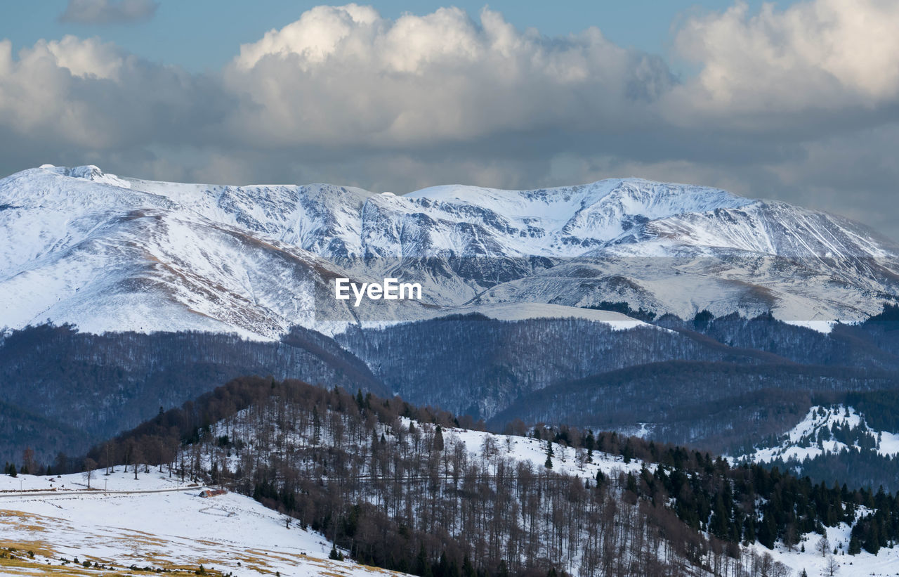 Scenic view of snowcapped mountains against sky