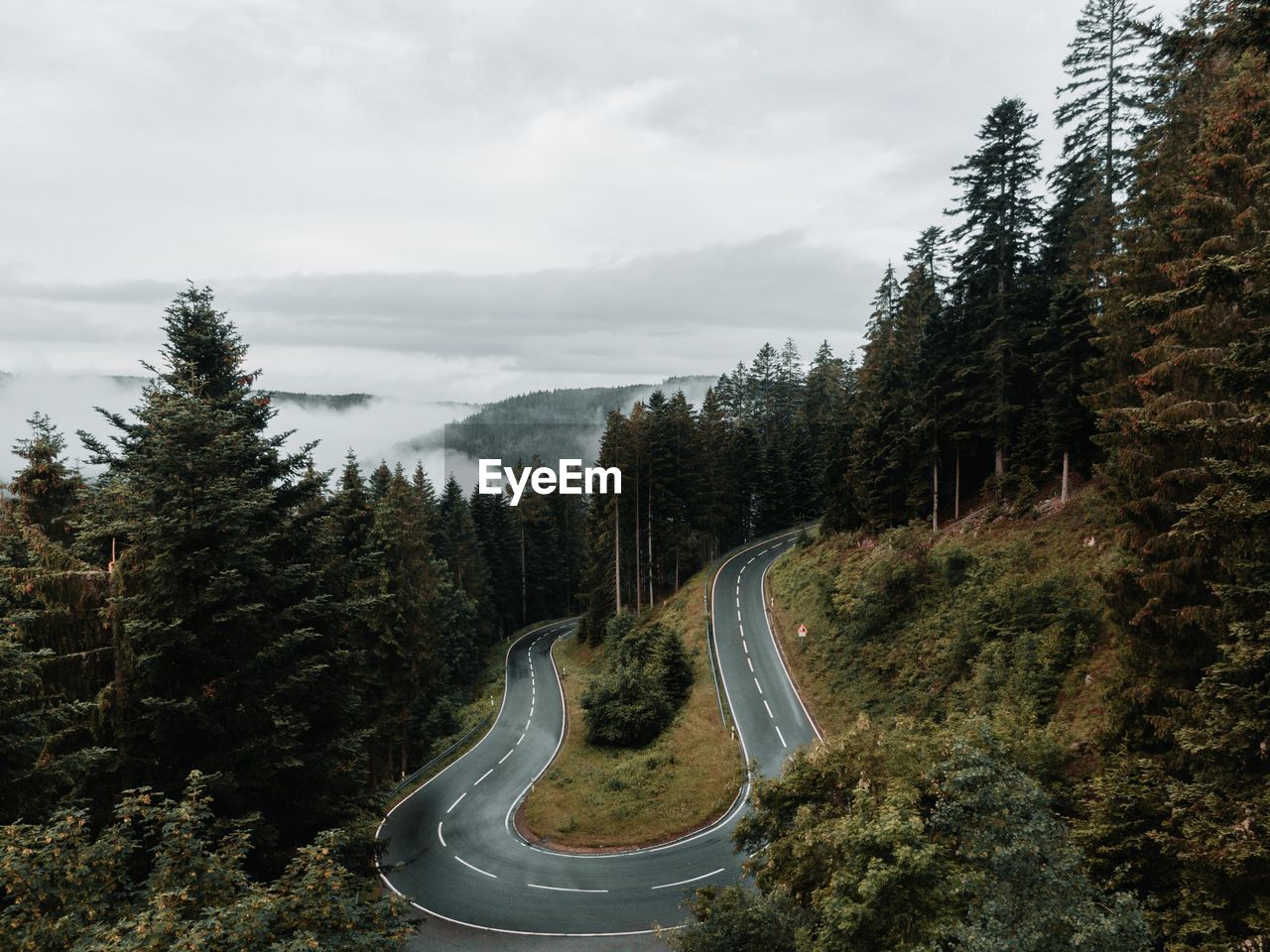 Winding road on mountain against sky