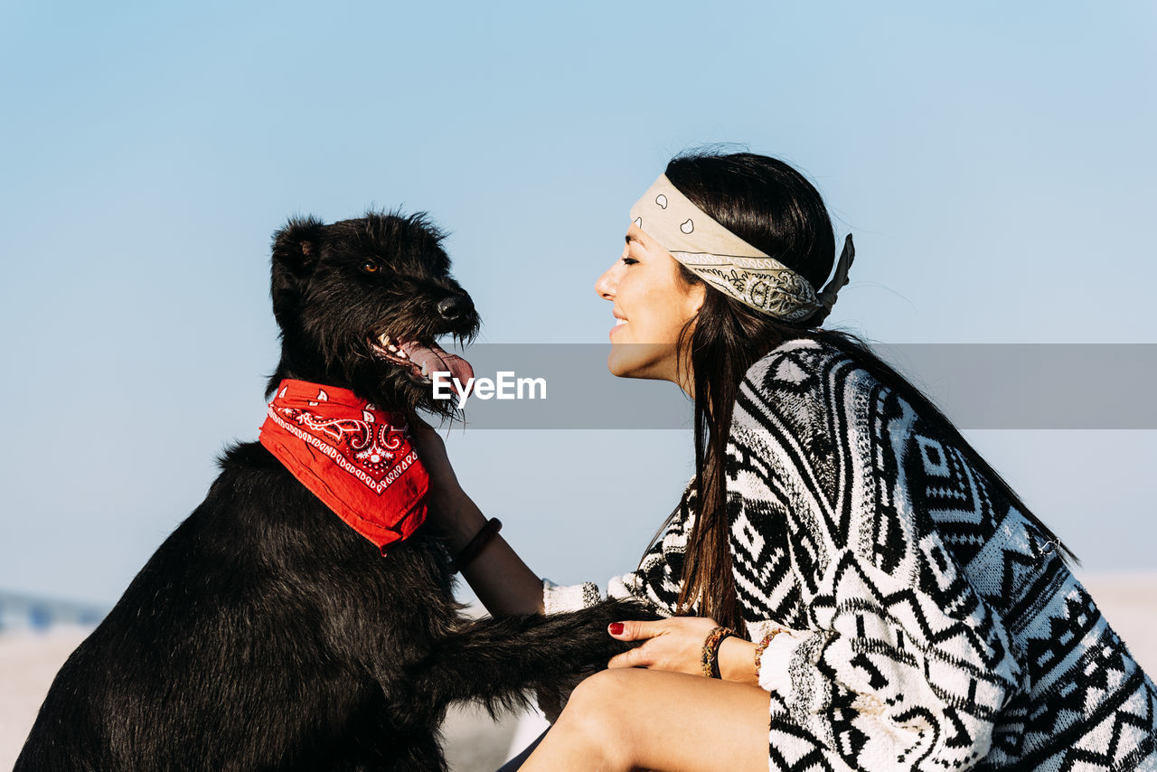 Smiling woman petting dog