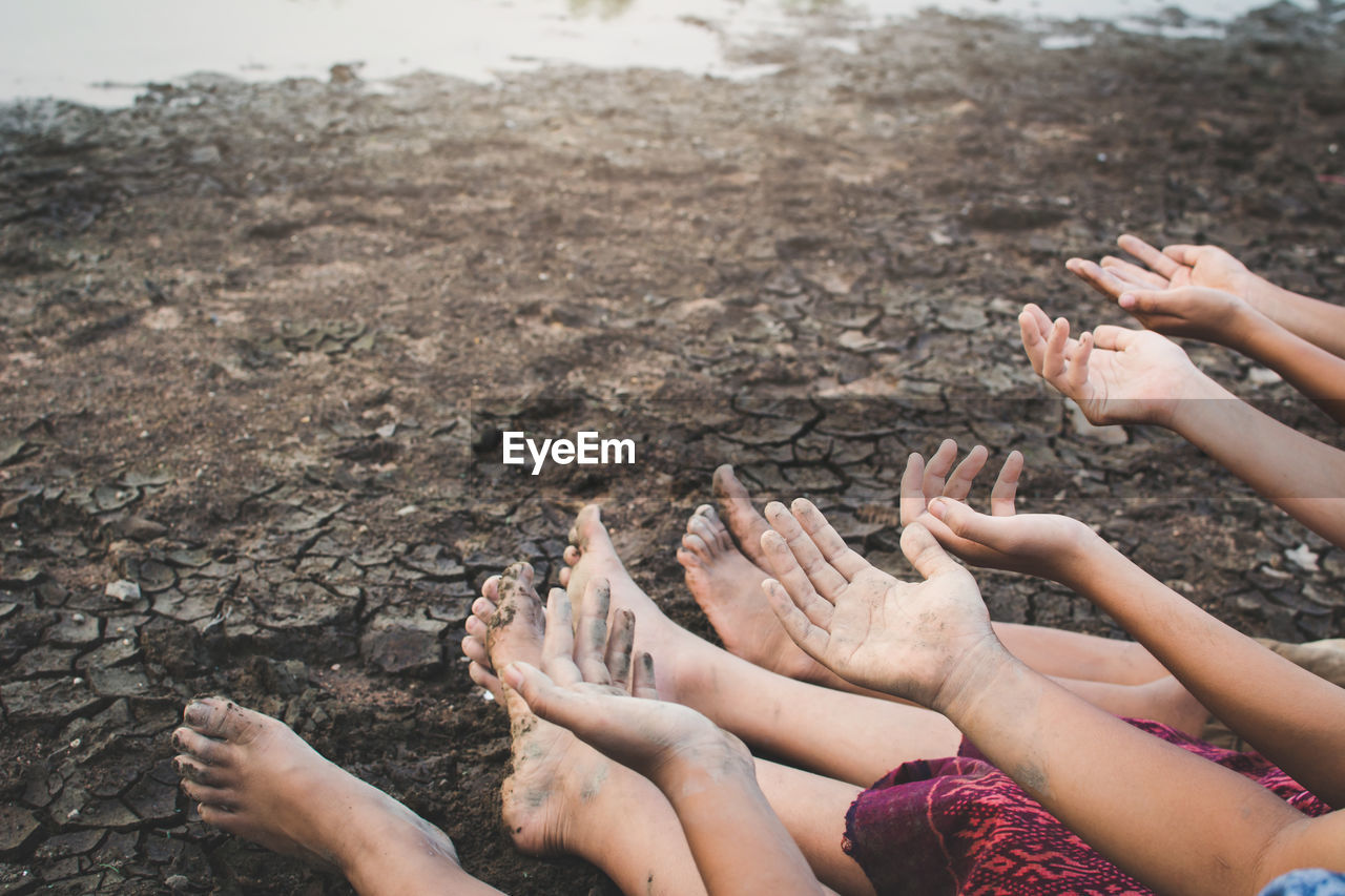 Low section of people sitting on arid field