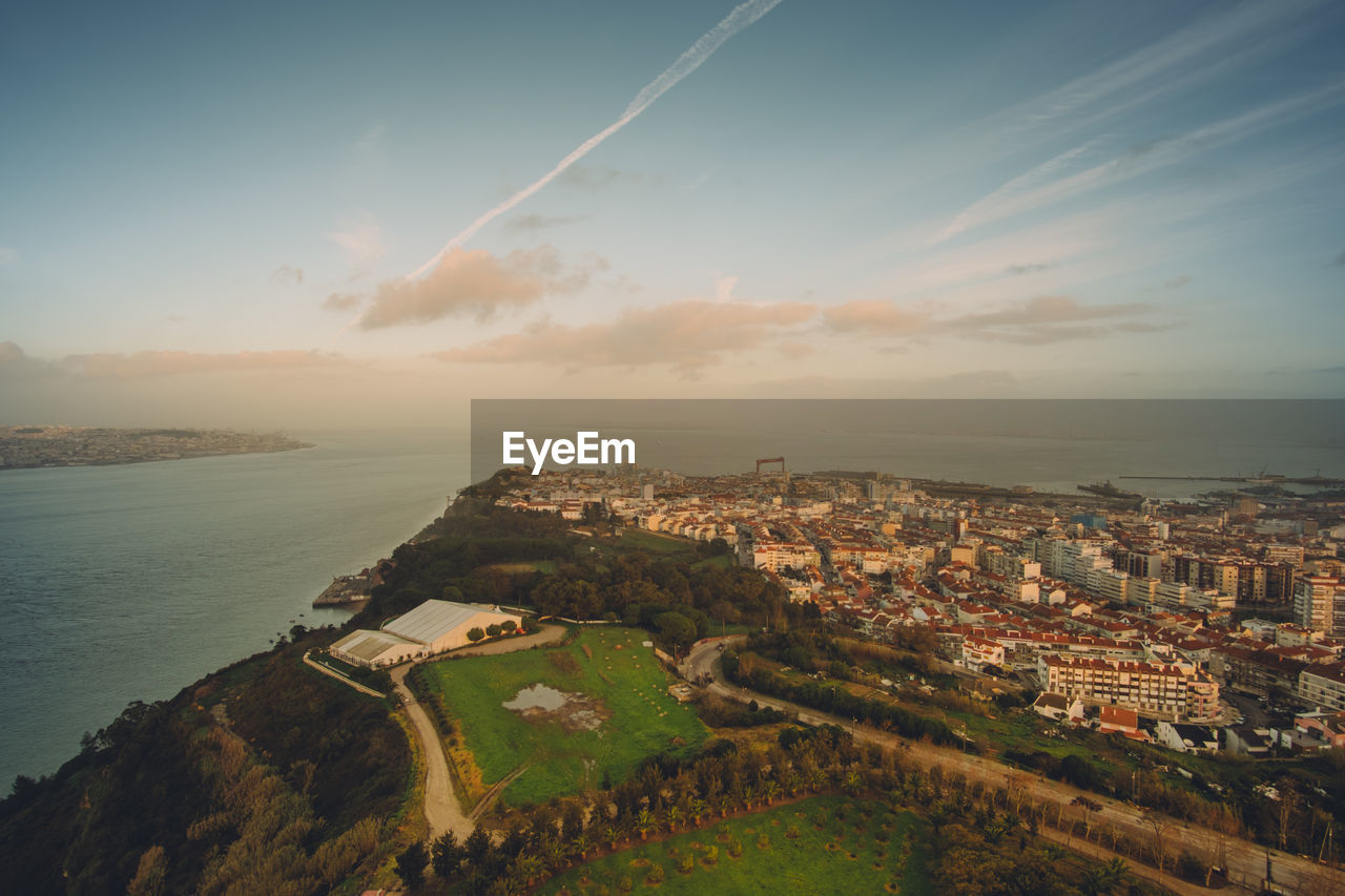 High angle view of townscape by sea against sky