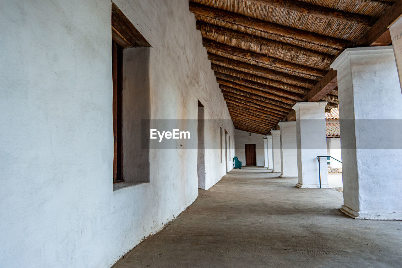 EMPTY CORRIDOR OF BUILDING WITH COLONNADE