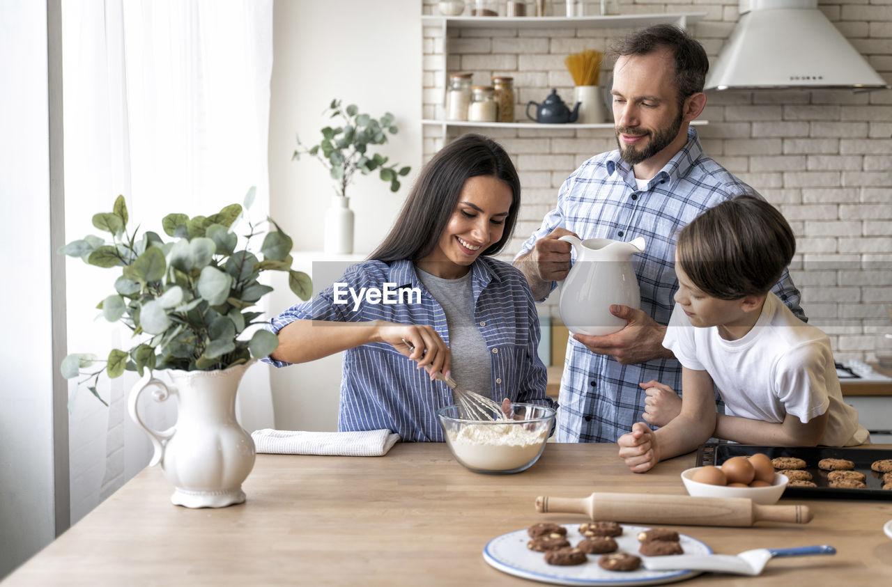 Family preparing food in kitchen at home