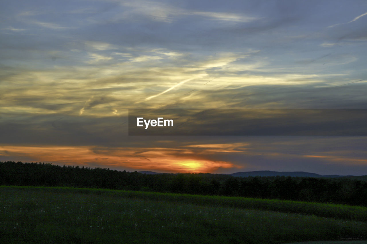 SCENIC VIEW OF SUNSET OVER FIELD
