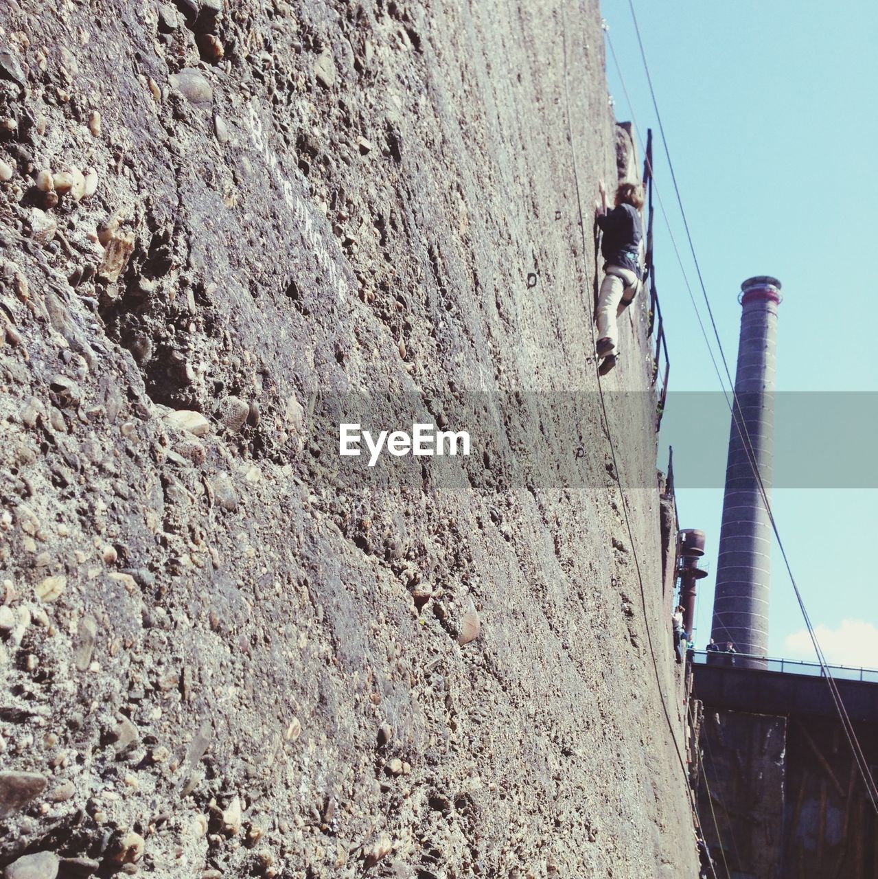 Low angle view of person rock climbing